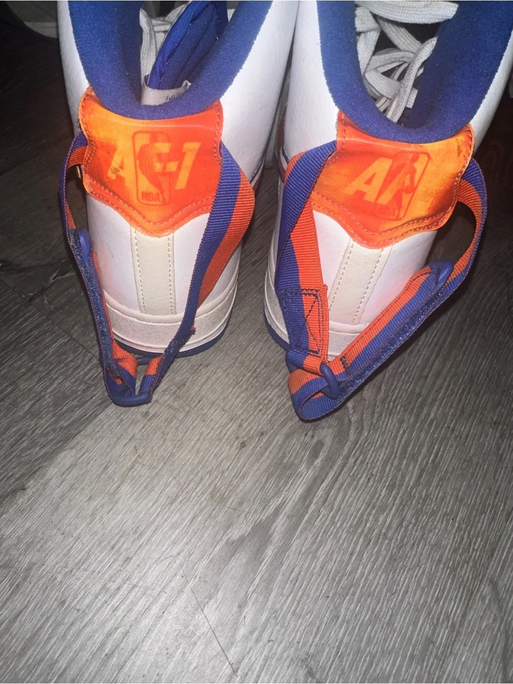 Nike White High-Top Sneakers with Orange Swoosh and Blue Accents